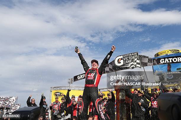 Kurt Busch, driver of the Haas Automation Chevy SS, celebrates in victory lane after winning the STP Gas Booster 500 at the Martinsville Speedway in...