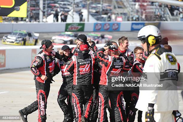 The pit crew for the Haas Automation Chevy SS driven by Kurt Busch celebrate on pit road after winning the STP Gas Booster 500 at the Martinsville...