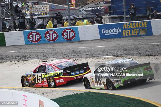 The 5-Hour Energy Toyota Camry driven by Clint Bowyer and the Lowe's Chevy SS driven by Jimmie Johnson on track during the running of the STP Gas...