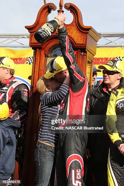 Kurt Busch, driver of the Haas Automation Chevy SS, gets a kiss from his girl friend Patricia Driscoll in victory lane after winning the STP Gas...