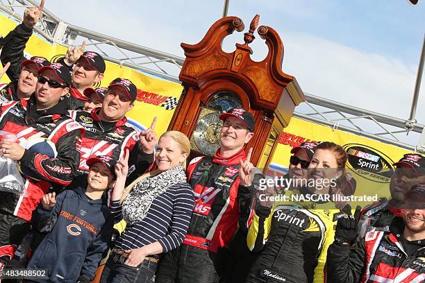 Kurt Busch, driver of the Haas Automation Chevy SS, and his team celebrate in victory lane after winning the STP Gas Booster 500 at the Martinsville...