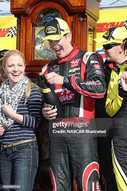 Kurt Busch, driver of the Haas Automation Chevy SS, celebrates with champagne in victory lane after winning the STP Gas Booster 500 at the...