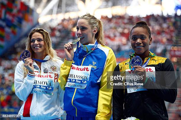 Gold medallist Jennie Johansson of Sweden poses with silver medallist Alia Atkinson of Jamaica and bronze medallist Yuliya Efimova of Russia during...
