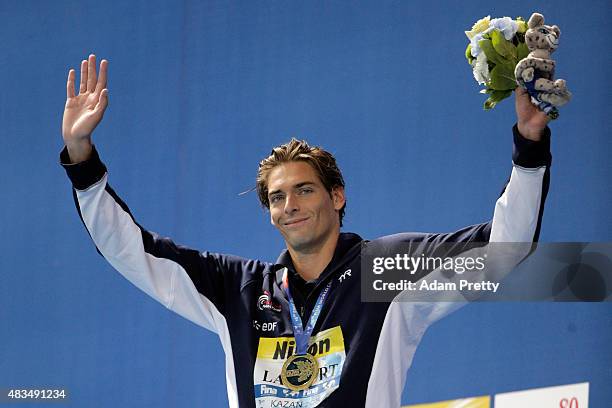 Gold medallist Camille Lacourt of France celebrates during the medal ceremony for the Men's 50m Backstroke Final on day sixteen of the 16th FINA...