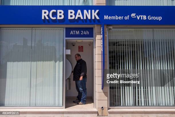 Customer uses an automated teller machine inside a Russian Commercial Bank Cyprus Ltd. Bank branch in Limassol, Cyprus, on Tuesday, April 8, 2014....