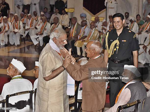 Prime Minister Narendra Modi meets freedom fighters during 'At Home" reception for freedom fighters at Durbar Hall of Rashtrapati Bhavan on August 9,...