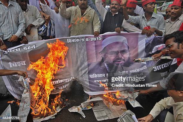 Members of Rashtriya Krantikari Samajwadi Party burn a banner with the images of IS leader Abu Bakr al-Baghdadi, Head of the banned Islamic charity...