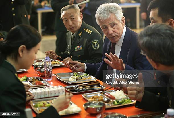 Secretary of Defense Chuck Hagel have lunch with students at the mess hall of the Non-Commissioned Officer Academy during a tour April 9, 2014 in...