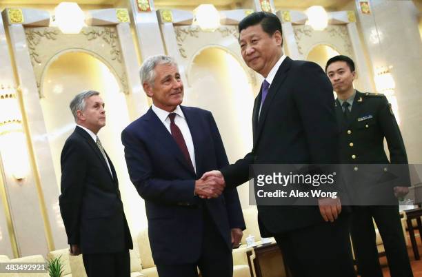 Secretary of Defense Chuck Hagel shakes hands with Chinese President Xi Jinping during a meeting at the Great Hall of the People April 9, 2014 in...