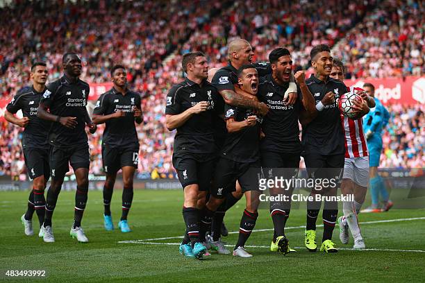 Philippe Coutinho of Liverpool celebrates with team mates James Milner, Martin Skrtel, Emre Can and Roberto Firmino of Liverpool as he scores their...