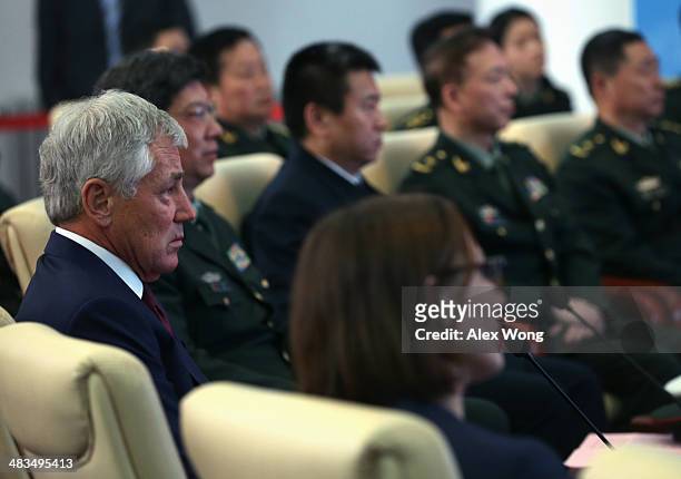 Secretary of Defense Chuck Hagel watches a short presentation film about the Non-Commissioned Officer Academy during a tour April 9, 2014 in...