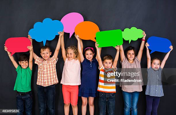 speech bubbles - holding speech bubble stock pictures, royalty-free photos & images