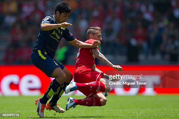 Dario Bottinelli of Toluca fights for the ball with Enrique Perez of Morelia during a 3rd round match between Toluca and Morelia as part of the...