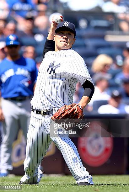 Masahiro Tanaka of the New York Yankees fields a hit by Chris Colabello of the Toronto Blue Jays in the fourth inning on August 9, 2015 at Yankee...