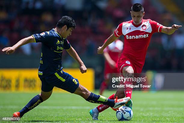 Moises Velasco of Toluca battles for the ball with Enrique Perez of Morelia during a 3rd round match between Toluca and Morelia as part of the...