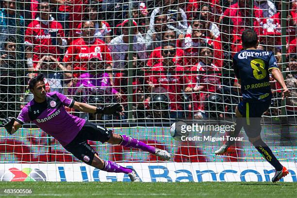 Juan Pablo Rodriguez of Morelia scores the first goal of his team from the penalty spot past Alfredo Talavera goalkeeper of Toluca during a 3rd round...