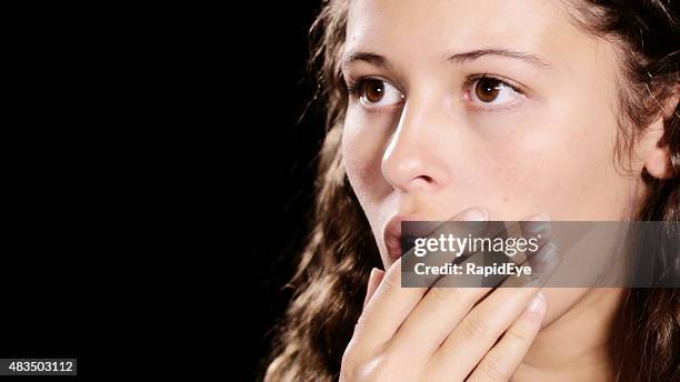 beautiful brown-eyed woman looking shocked, hand over mouth - brown eyed girls stock pictures, royalty-free photos & images