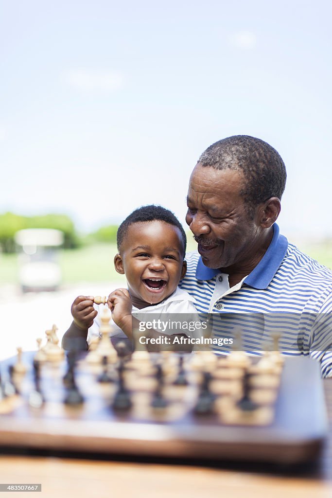 African grandfather having a good laugh with his grandchild