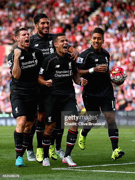 Philippe Coutino of Liverpool celebrates after scoring the winning goal with team mates Emre Can,Roberto Firmino and James Milner during the Barclays...