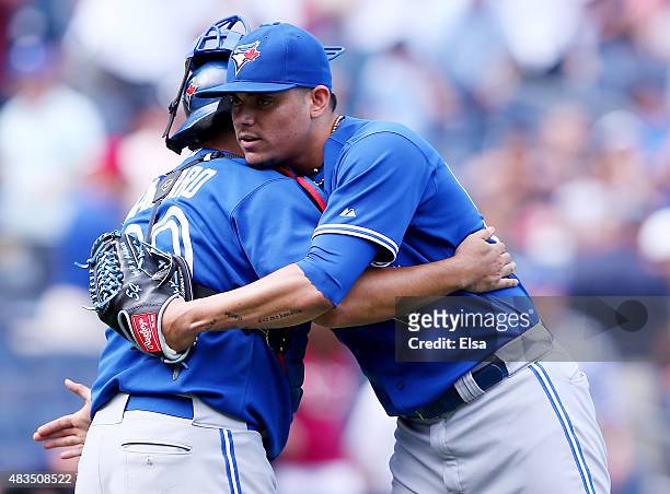 Dioner Navarro and Roberto Osuna of the Toronto Blue Jays celebrate the 2-1 win over the New York Yankees on August 9, 2015 at Yankee Stadium in the...