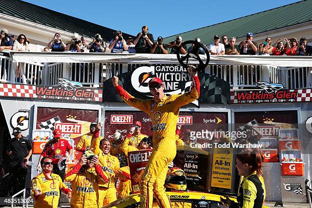 Joey Logano, driver of the Shell Pennzoil Ford, celebrates in victory lane after winning the NASCAR Sprint Cup Series Cheez-It 355 at the Glen at...