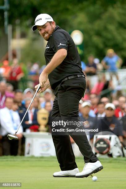 Shane Lowry of Ireland celebrates as his birdie putt falls in the cup on the 18th green during the final round of the World Golf Championships -...