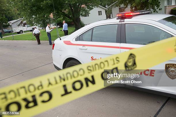 Police investigate a drive-by shooting which occurred a few blocks from the Canfield Green Apartments in Ferguson where a memorial service had just...