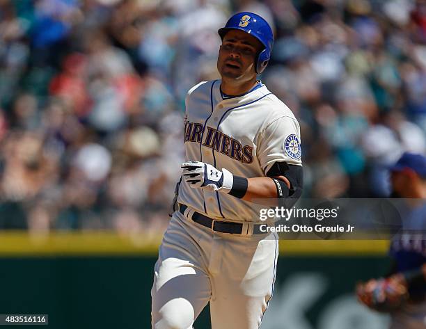 Jesus Montero of the Seattle Mariners rounds the bases after hitting a two-run homer against the Texas Rangers in the fourth inning at Safeco Field...