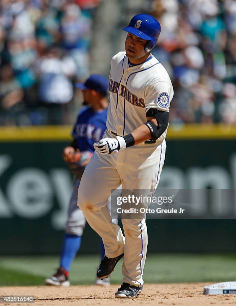 Jesus Montero of the Seattle Mariners rounds the bases after hitting a two-run homer against the Texas Rangers in the fourth inning at Safeco Field...