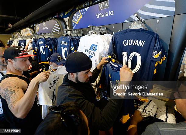 Fans buy t-shirt of Giovani Dos Santos and Steven Gerrad of the Los Angeles Galaxy before the start of soccer match between Los Angeles Galaxy and...