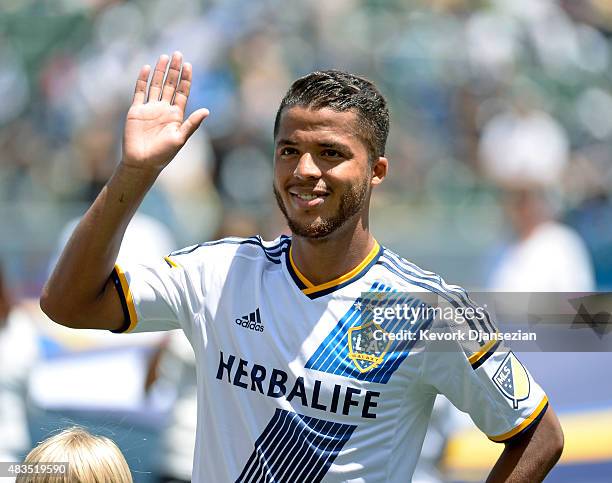 Giovani Dos Santos of the Los Angeles Galaxy acknowledges cheers from fans as he makes his MLS debut before the start of soccer match between Los...