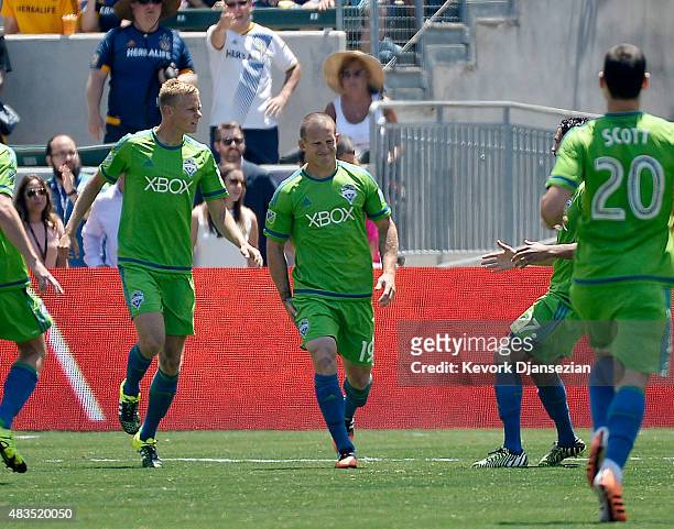 Chad Barrett of the Seattle Sounders holds his leg as he celebrates after scoring a goal against Los Angeles Galaxy during the first half at StubHub...