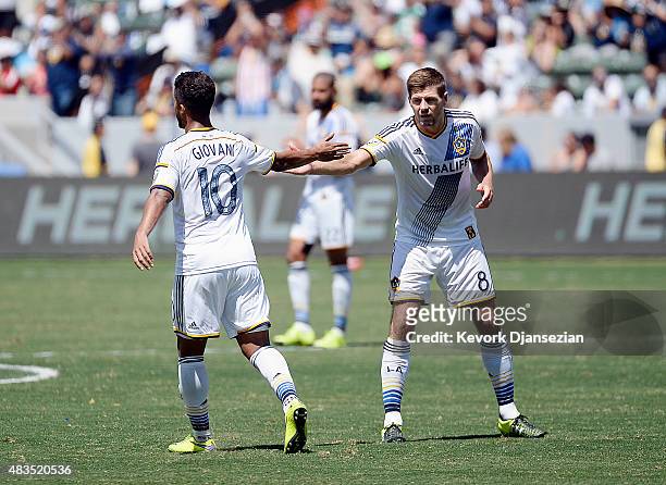 Steven Gerrard of the Los Angeles Galaxy congratulates Giovani Dos Santos as he walks off the pitch to be replaced against Seattle Sounders during...