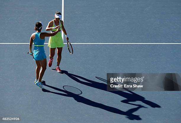 Yi-Fan Xu and Saisai Zheng of China high five one another during their match against Anabel Medina Garrigues and Arantxa Parra Santonja of Spain in...