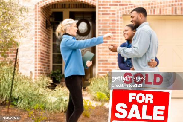 real estate: african descent couple buys home. real estate agent gives key. - house key 個照片及圖片檔