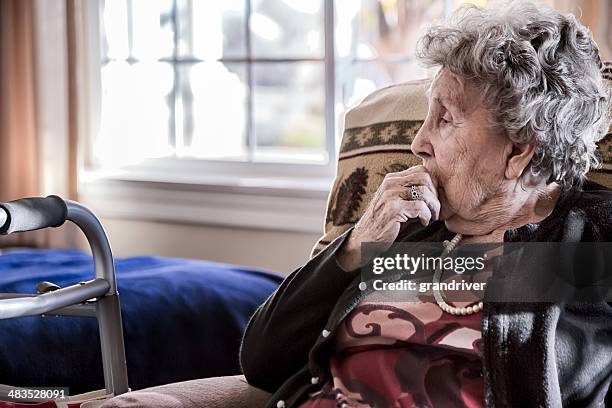 elderly woman in a nursing home - lonely senior stock pictures, royalty-free photos & images