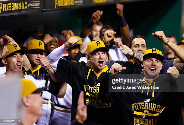 Burnett and Jordy Mercer of the Pittsburgh Pirates reacts in the dugout with teammates following a three run home run in the 7th inning by Jung Ho...