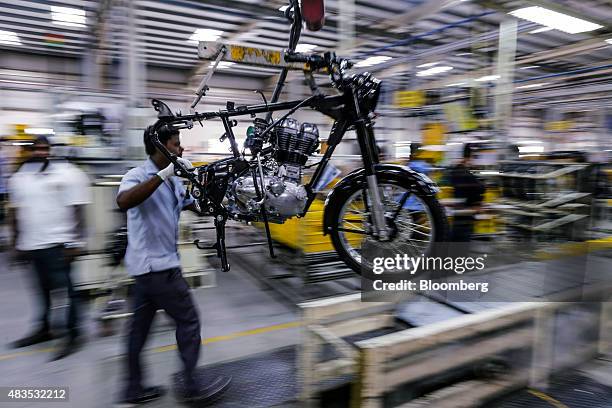 An employee moves a Royal Enfield Motors Ltd. Classic 350 motorcycle along the production line at the company's manufacturing facility in Chennai,...