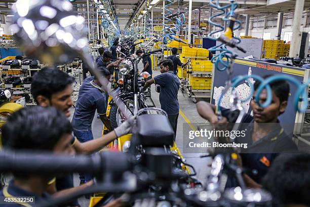 Employees assemble Royal Enfield Motors Ltd. Classic 350 motorcycles moving on a conveyor on the production line at the company's manufacturing...