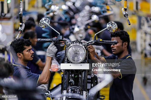 Employees assemble Royal Enfield Motors Ltd. Classic 350 motorcycles moving on a conveyor on the production line at the company's manufacturing...