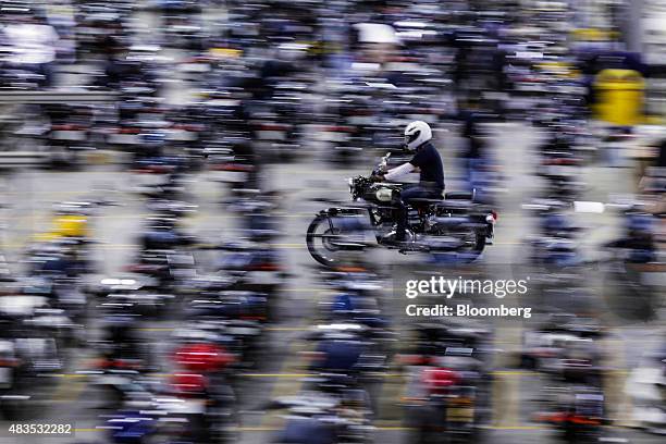 An employee rides a Royal Enfield Motors Ltd. Classic 350 motorcycle at the company's manufacturing facility in Chennai, India, on Tuesday, July 14,...