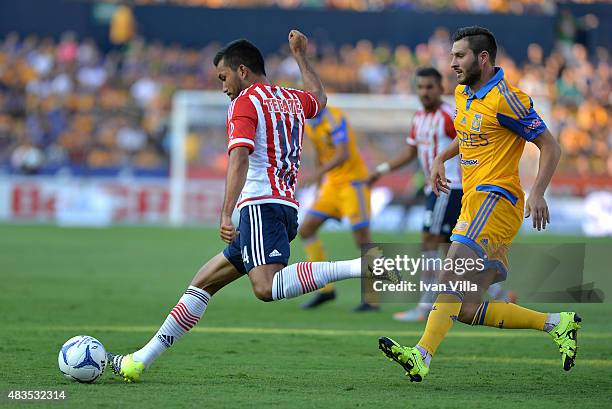 Andre Gignac of Tigres competes for the ball with Hedgardo Marin of Chivas during a 3rd round match between Tigres UANL and Chivas as part of the...