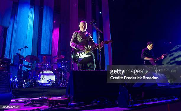 Drummer Jimmy Chamberlin, vocalist Billy Corgan, and guitarist Jeff Schroeder of the Smashing Pumpkins perform at the Ascend Amphitheater on August...