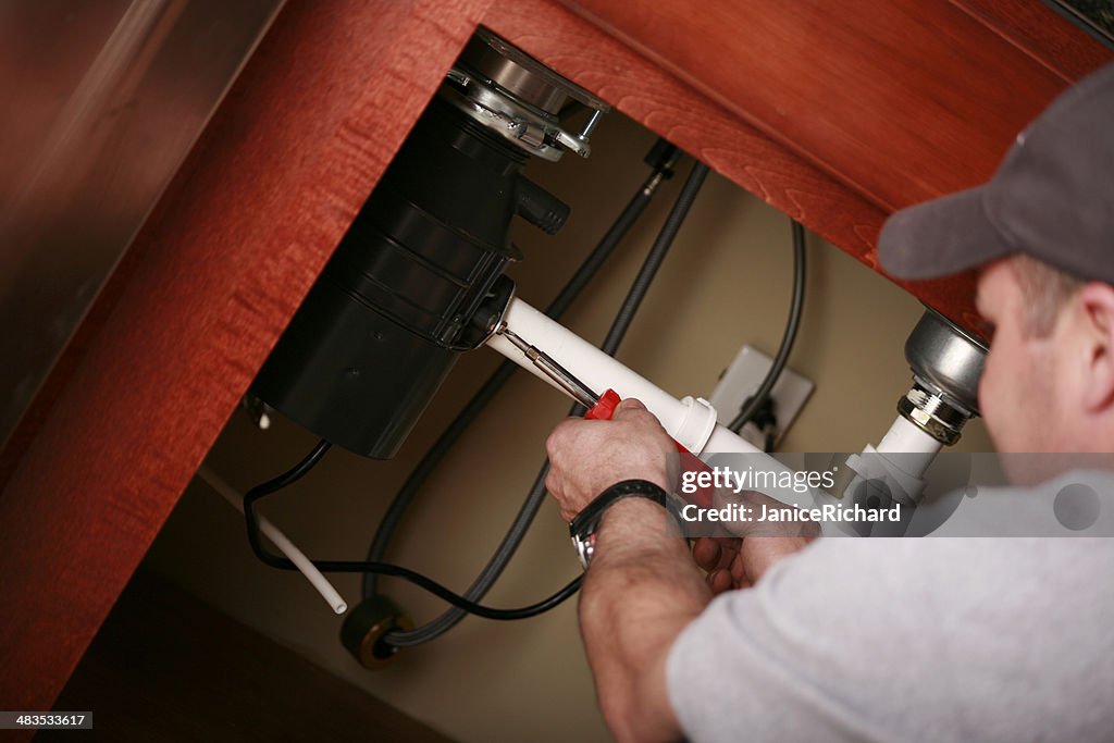 Professional Plumber Installing a Kitchen Sink