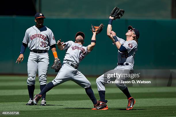 Colby Rasmus of the Houston Astros catches a fly ball hit off the bat of Brett Lawrie of the Oakland Athletics while colliding with Jose Altuve in...