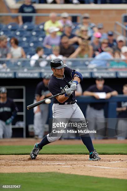 Jesus Montero of the Seattle Mariners makes some contact at the plate during the game against the San Diego Padres at Peoria Sports Complex on...