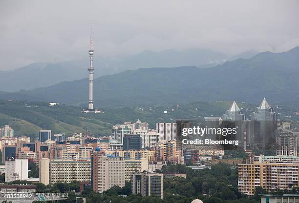 Commercial and residential property sits on the city skyline in front of the Almaty Television Tower in Almaty, Kazakhstan, on Friday, June 26, 2015....