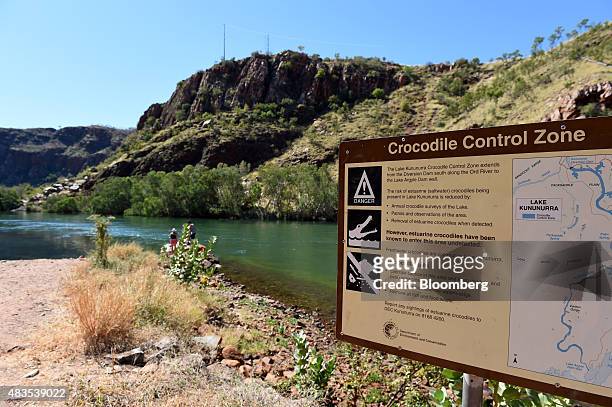 Warning sign alerting people to the risk of crocodiles is displayed along the Ord River at Lake Argyle, 70 kilometers south of Kununnura, Australia,...