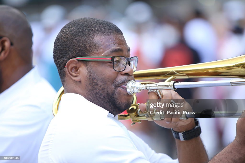 Trombone player sets the stage for a joyous baptism along...