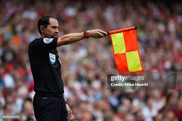 Assistant referee Stephen Child flags offside during the Barclays Premier League match between Arsenal and West Ham United at Emirates Stadium on...